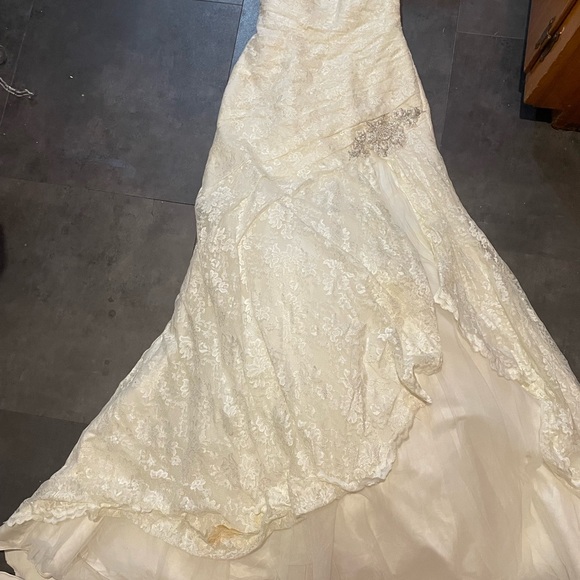 David's Bridal Lace Strapless Wedding Gown in the color “Ivory”. - Picture 3 of 16